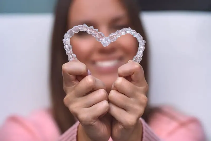 Woman holding clear aligners