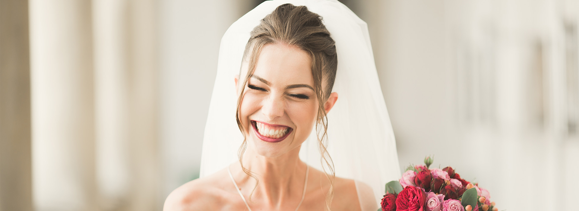 The image features a bride in wedding attire, smiling and looking towards the camera.