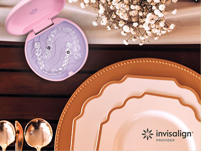 The image displays a collection of tableware on a wooden surface, including plates, bowls, and a lid with a design. There is also a small pink object that appears to be an eye care product next to the tableware.
